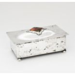 A Connell electroplated metal and enamel casket, rectangular form on four bun feet, the hinged cover