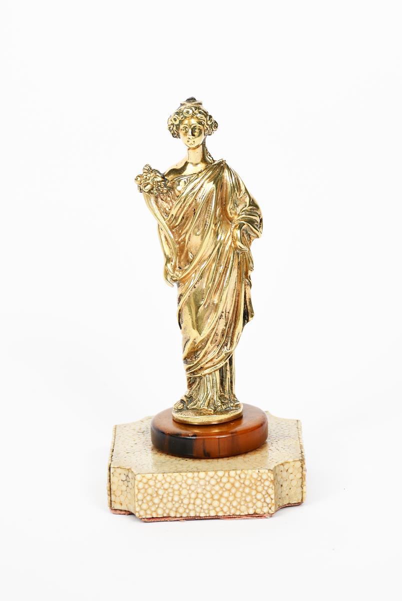 A gilt metal classical figure, retailed by Callow, Mount Street, London, cast as a standing woman in