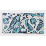 Two William De Morgan Persian tiles, painted with stylised foliage fronds in dark and pale blue on a