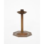 A Cotswold's school patinated copper candlestick, the octagonal base with central dome,