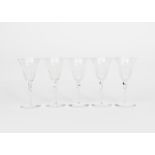 A set of five James Powell & Sons Whitefriars engraved flint glass wine glasses, shallow domed