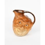 A Martin Brothers stoneware face jug designed by Robert Wallace Martin, dated 1899, modelled in