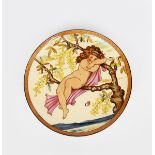 A Mintons Art Pottery Studio wall charger in the manner of W S Coleman, painted with a young girl