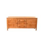 An oak sideboard by Don Foxman Craven, rectangular section on turned octagonal bun feet, three