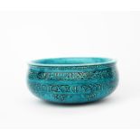 A Theodore Deck pottery Islamic bowl, shallow form with rounded base, modelled in low relief with