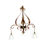 An Art Nouveau copper and brass three branch ceiling light, three copper foliate arms, with