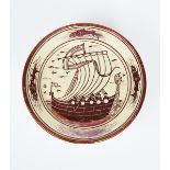 A lustre pottery plate, painted to the well with manned sailing vessel, the rim with four stylised