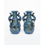 A pair of C H Brannam Pottery Dragon vases by Frederick Bowden, dated 1909, probably retailed by