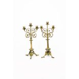 A pair of bronze candlesticks the design attributed to Eugene Emmanuel Violet le Duc, tripod foot