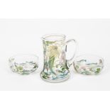 An Art Nouveau Scottish enamelled glass jug and two bowls by Hannah Walton, the jug enamelled with a