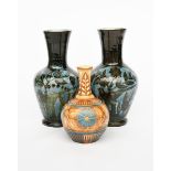 A pair of tall and early C H Brannam Pottery vases, dated 1884, shouldered form with flaring