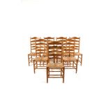 A set of seven natural ash Gimson ladderback (no.3) chairs by Neville Neal, with rush seats,