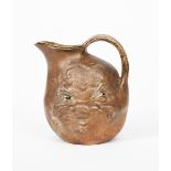 An unusual and rare Martin Brothers stoneware face jug by Robert Wallace Martin, dated 1897,
