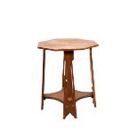 An oak occasional table, octagonal top on flaring plank legs with cut-out heart motif and copper