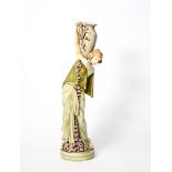 A tall Art Nouveau Amphora Pottery figure of a maiden holding an urn, model no.5021, modelled