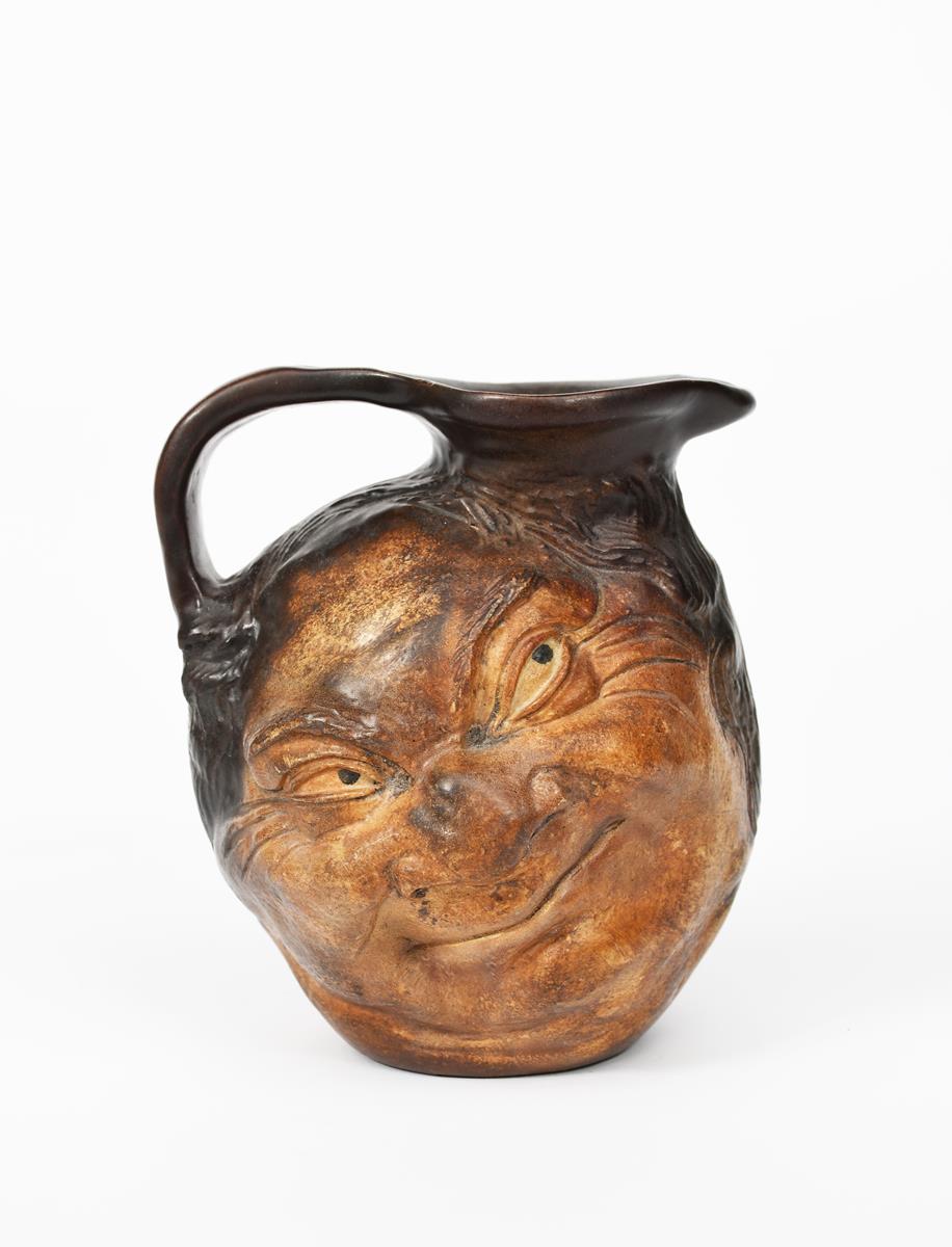 A Martin Brothers stoneware face jug by Robert Wallace Martin, modelled in relief with a smiling - Image 2 of 4