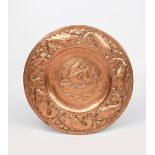 A Newlyn Industrial Classes copper charger by John Mackenzie worked by P Hodder, repousse hammered