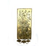 An Aesthetic Movement brass wall sconce, the rectangular back-plate stamped with exotic birds flying