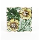 A William De Morgan Merton Abbey K L Rose tile, painted with two flowers in shades of yellow,
