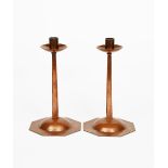 A pair of Cotswold's School copper candlesticks designed by Ernest Gimson, octagonal base with domed