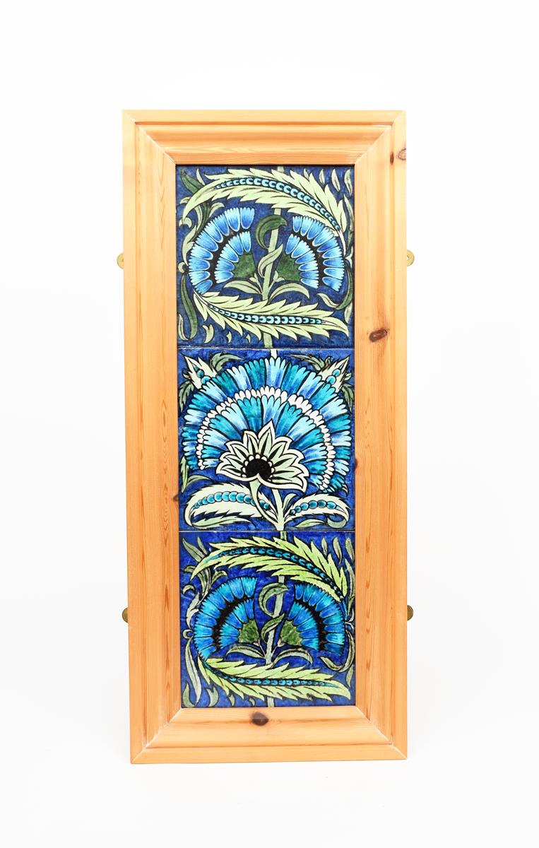 Three large William De Morgan Fan tiles, painted in shades of blue, turquoise and green on a white