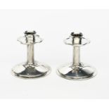 A pair of Liberty polished pewter candlesticks designed by Archibald Knox, model no.023, domed