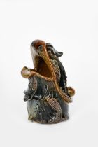 A Martin Brothers stoneware grotesque spoon warmer by Robert Wallace Martin, dated 1880, modelled as