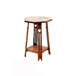 An oak occasional table, octagonal top on flaring plank legs with cut out leaf motif, unsigned, 74.