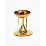 A Glasgow School brass candlestick in the manner of Talwin Morris, tapering cylindrical base with
