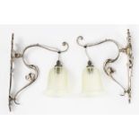 A pair of Art Nouveau wall lights, silvered metal, scrolling foliate form with James Powell satin