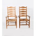 A pair of natural ash LCC armchairs by Neville Neal, with rush seat, one waxed, stamped marks,