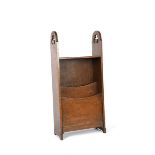 An oak magazine rack, rectangular form, with two partitions, the rounded plank ends with pierced