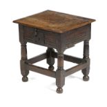 A CHARLES I OAK BOX STOOL C.1640 the hinged lid revealing a divided interior, part of base