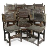 TWENTY-ONE SPANISH LEATHER MOUNTED CHAIRS 17TH CENTURY AND LATER in chestnut and walnut, the leather