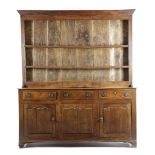 A GEORGE III OAK DRESSER LATE 18TH CENTURY the raised plate rack with three shelves, the base with