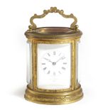 A FRENCH GILT BRASS OVAL CARRIAGE CLOCK LATE 19TH CENTURY the brass eight day movement striking on a