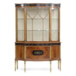 A SHERATON REVIVAL SATINWOOD AND GILTWOOD SERPENTINE DISPLAY CABINET IN THE MANNER OF WRIGHT &