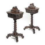 A PAIR OF VICTORIAN OAK TEAPOYS C.1850-60 each with carved leaf decoration, the hinged top with a