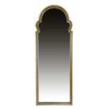A WALNUT AND GILTWOOD WALL MIRROR IN GEORGE II STYLE the later arched plate within a moulded leaf
