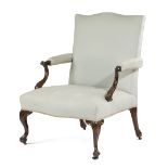 AN EARLY GEORGE III LIBRARY ARMCHAIR C.1760-70 with a serpentine back, above a padded seat and