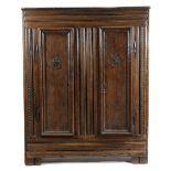 AN OAK CUPBOARD 17TH CENTURY with thumbnail mouldings and a pair of panelled doors enclosing shelves