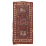 A KAZAK RUG CENTRAL CAUCASUS, C.1890 the mid-indigo field with five panels of hooked motifs enclosed