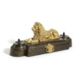 A GILT AND PATINATED BRONZE INKWELL EARLY 19TH CENTURY the recumbent lion between a pair of lidded