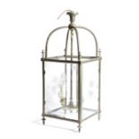 A BRASS AND CUT-GLASS HALL LANTERN with four star-cut and bevelled panes, beneath an arched frame,