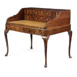 A GEORGE II MAHOGANY DESK C.1740 the open top fitted with six drawers, above a slide-out writing