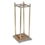 A BRASS AND CAST IRON UMBRELLA STAND LATE 19TH CENTURY with four divisions and a lift-out tray 62.