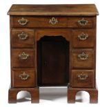 A GEORGE II MAHOGANY KNEEHOLE DESK C.1750 the caddy moulded top above an arrangement of eight