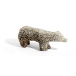 A CARVED FOSSILISED WHALEBONE MODEL OF A POLAR BEAR POSSIBLY INUIT 31cm long