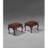 A PAIR OF GEORGE II WALNUT STOOLS C.1735-40 each with a later drop-in velvet covered seat, above a