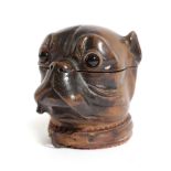 A BLACK FOREST CARVED LINDENWOOD DOG'S HEAD INKWELL LATE 19TH CENTURY in the shape of a pug or